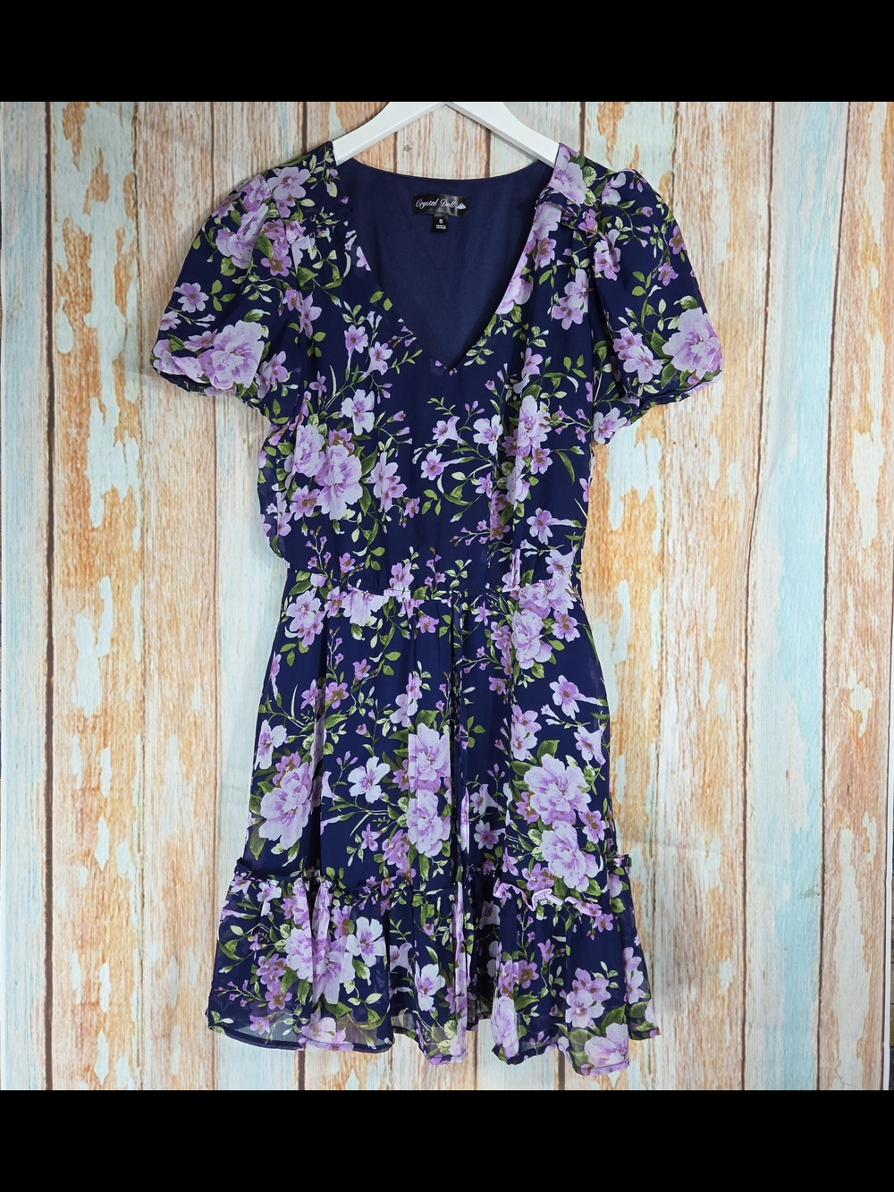 Crystal Doll Navy Mini Dress with Lilac Floral Print And Ruffle Hem. Size Small
